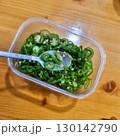 The images show a container of thinly sliced green chili peppers, which are often used as a spicy side dish or garnish in Korean cuisine. 130142790