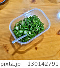The images show a container of thinly sliced green chili peppers, which are often used as a spicy side dish or garnish in Korean cuisine. 130142791