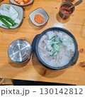 The images show a bowl of steaming dwaeji gukbap, a popular Korean pork soup with rice, served with various side dishes. 130142812