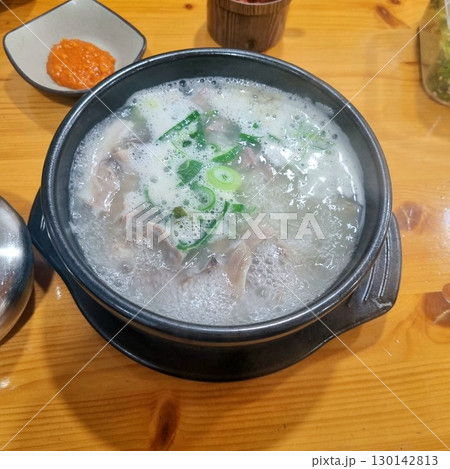 The images show a bowl of steaming dwaeji gukbap, a popular Korean pork soup with rice, served with various side dishes. 130142813