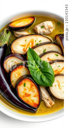 Flavorful chicken and eggplant dish served in aromatic broth with fresh herbs and spices for a delightful dining experience 130143343