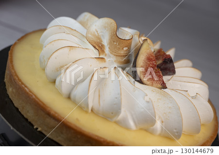 Sunny and Bright Orange Lemon Citrus Meringue Pie on a black plate on white background Sunny and Bright Orange Lemon Citrus Meringue Pie on a black plate on white background 130144679