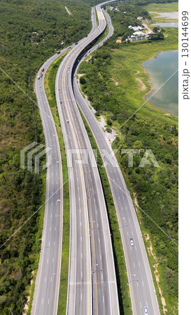 Drone shot The M6 motorway Nakhon Ratchasima Province - Bang Pa-in Lam Ta Khong River and Mountain. Motorway Korat Thailand Drone shot The M6 motorway Nakhon Ratchasima Province - Bang Pa-in Lam Ta Khong River and Mountain. Motorway Korat Thailand 130144699