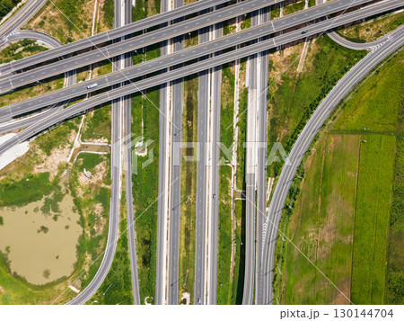 Drone shot a large highway interchange crossing over green farmlands in Thailand Drone shot a large highway interchange crossing over green farmlands in Thailand 130144704