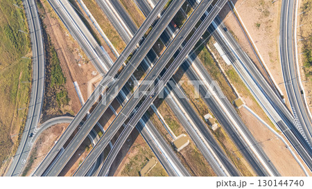 Drone shot aerial view of high angle view of intersection across the bridge against the countryside highway 130144740