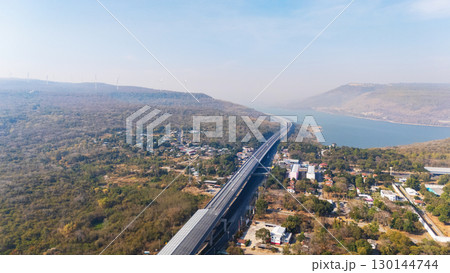 Drone shot aerial view landscape of the M6 motorway Expressway Nakhon Ratchasima Province - Bang Pa-in. Lam Ta Khong River and Mountain. Drone shot of scenic landscape rural place traffic. Nakhon Drone shot aerial view landscape of the M6 motorway Expressway Nakhon Ratchasima Province - Bang Pa-in. Lam Ta Khong River and Mountain. Drone shot of scenic landscape rural place traffic. Nakhon 130144744