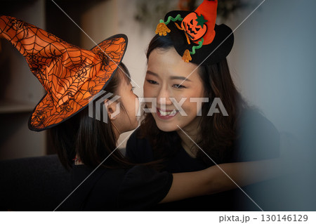 Halloween Joy. Mother and daughter sharing a loving moment while wearing witch hats. Halloween Joy. Mother and daughter sharing a loving moment while wearing witch hats. 130146129