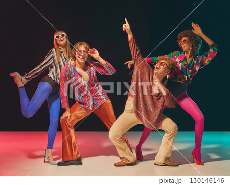 Retro group posing in disco dance formation with playful gestures 130146146
