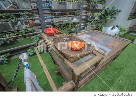 Aug 23 2025 Wooden Cart Displaying Food Items and Utensils on Green Outdoor 130146168