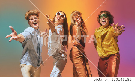 Vintage styled group of four dancing in disco light with expressive retro outfits 130146189