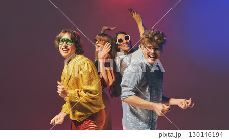 Retro styled friends posing together in vintage disco fashion 130146194