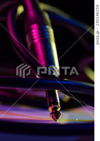Close up of audio jack cable with neon lights retro music style 130146259