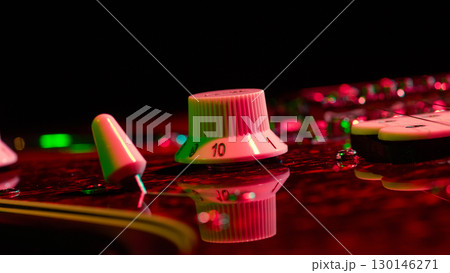 Guitar amplifier knob with neon reflection close up Guitar amplifier knob with neon reflection close up 130146271