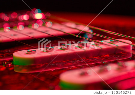 Electric guitar pickup detail glowing in neon colors 130146272