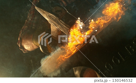 The blacksmith manually forging the molten metal on the anvil in smithy with spark fireworks 130146532