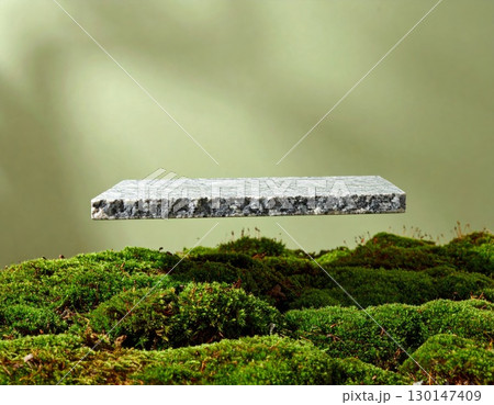 Square Stone Floating Above Green Moss with a Soft Gradient Background 130147409