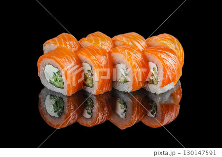 Fresh salmon sushi rolls with cream cheese and cucumber on black background 130147591