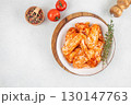 Raw marinated chicken wings with spices and herbs on white plate. top view. copy space 130147763