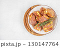 Raw marinated pork ribs with spices and herbs on white plate. top view. copy space 130147764