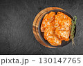 Raw marinated turkey fillet with spices and herbs on black plate. top view. copy space 130147765