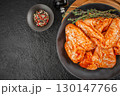 Raw marinated turkey wings with spices and herbs on black plate. top view. copy space 130147766