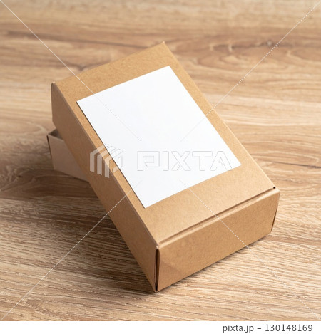 Simple Brown Cardboard Box with White Label on Light Brown Wooden Surface 130148169