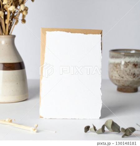 Blank Card Mockup with Dried Flowers on a Neutral Background and Table Top in Studio 130148181