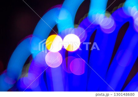 Out-of-focus golden and colorful light circles on a dark base 130148680