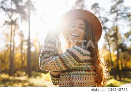 Outdoor atmospheric lifestyle. portrait of beautiful woman having fun in autumn forest. Warm autumn 130148721