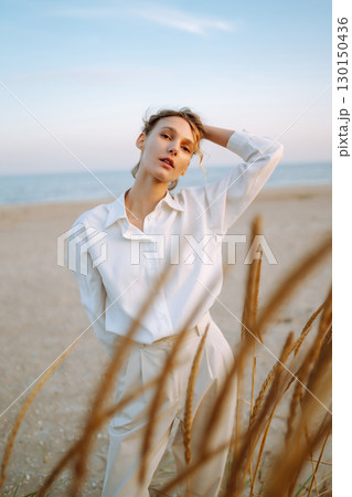 Stylish woman enjoying autumn weather outdoor. Fashion, style concept. People, lifestyle, relaxation 130150436