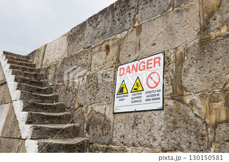 Danger Sign on Stone Harbour Steps at The Cobb, Lyme Regis, Dorset, England Danger Sign on Stone Harbour Steps at The Cobb, Lyme Regis, Dorset, England 130150581