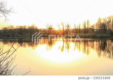 Peaceful Autumn Lake Surrounded By Vibrant Colorful Trees 130151809
