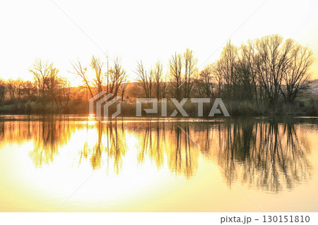 Peaceful Autumn Lake Surrounded By Vibrant Colorful Trees 130151810