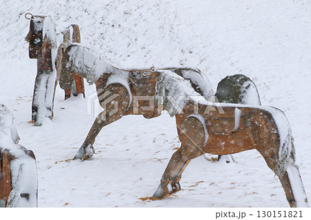Snow Covered Wooden Horses at Children Playground Snow Covered Wooden Horses at Children Playground 130151821