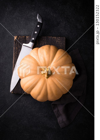 Raw fresh cut pumpkin on dark background 130152322