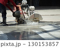 Workers are using a concrete road cutter. 130153857