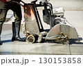 Workers are using a concrete road cutter. 130153858