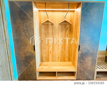 Wardrobe with hangers. Storage, organization, and hotel room furniture. Wardrobe with hangers. Storage, organization, and hotel room furniture. 130154165