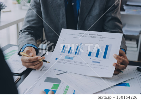 Accounting company provide finance and taxation planning for profitable cash flow, Auditor and accountant team working in office, analyze financial data and accounting record with calculator.Insight 130154226