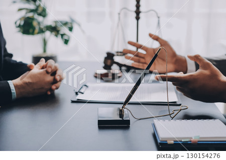 Lawyer explained to the client about the law that must be brought against the court case. Lawyer explained to the client about the law that must be brought against the court case. 130154276