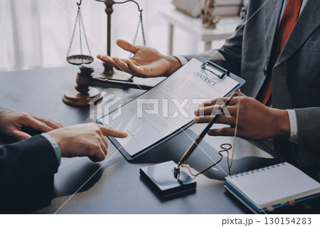 Lawyer explained to the client about the law that must be brought against the court case. Lawyer explained to the client about the law that must be brought against the court case. 130154283