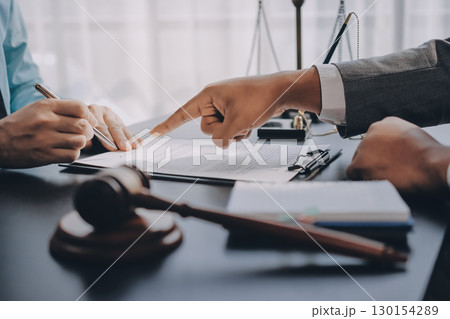 Lawyer explained to the client about the law that must be brought against the court case. Lawyer explained to the client about the law that must be brought against the court case. 130154289