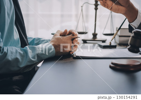 Lawyer explained to the client about the law that must be brought against the court case. 130154291