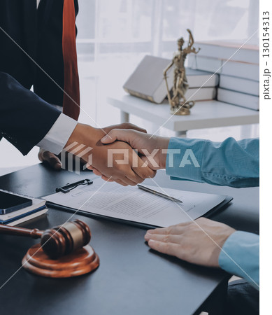 Lawyer explained to the client about the law that must be brought against the court case. Lawyer explained to the client about the law that must be brought against the court case. 130154313