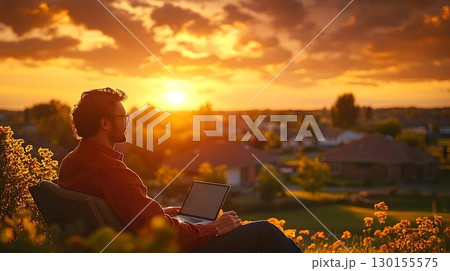 Man Working Outdoors with Laptop, Golden Sunset and Suburban Vie 130155575