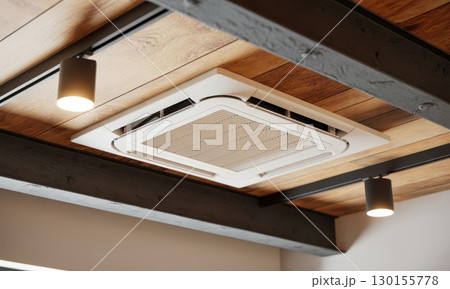 Modern cassette air conditioning unit integrated into rustic wooden ceiling with exposed beams 130155778