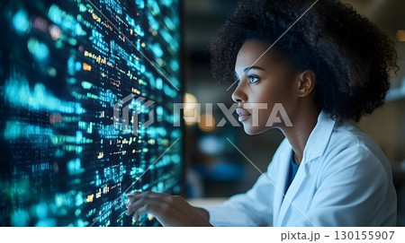 Focused researcher analyzes complex data on digital display screen 130155907