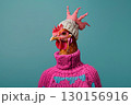 Stylish Chicken Wearing a Pink Sweater and Beanie Against a Blue Background 130156916