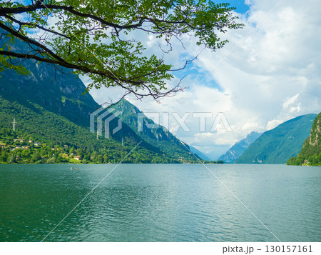 Serene Lake Idro Surrounded by Majestic Mountains and Cloudy sky, Italy, Crone Serene Lake Idro Surrounded by Majestic Mountains and Cloudy sky, Italy, Crone 130157161