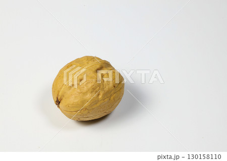 Unpeeled walnuts on white background. Walnut nut with shell. 130158110